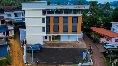 a building with a car parked in front of it at Hotel Diamond Castle in Manjeri