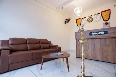 a living room with a couch and a table at Hotel Diamond Castle in Manjeri
