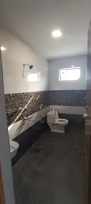 a bathroom with a toilet and a sink at Glasshouse Retreat by The Jungle stay groups in Vālpārai