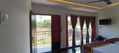 a room with a bed and a door with a balcony at Glasshouse Retreat by The Jungle stay groups in Vālpārai