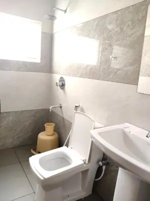 a bathroom with a toilet and a sink at Temple Bells in Mysore