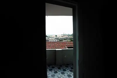 an open door with a view of a tile floor at Cute Corner Homestay,Ooty in Ooty