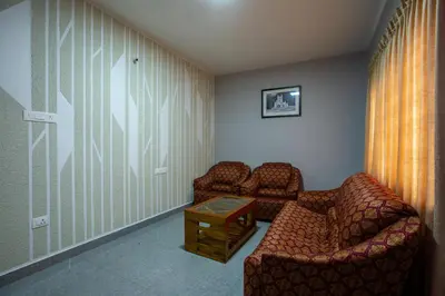 a waiting room with two chairs and a table at Cute Corner Homestay,Ooty in Ooty