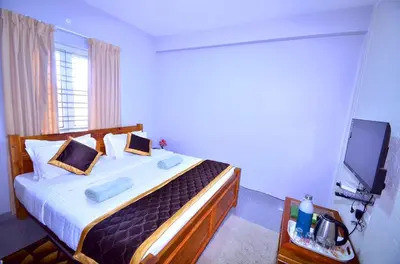 a bedroom with a bed and a television in it at Cute Corner Homestay,Ooty in Ooty
