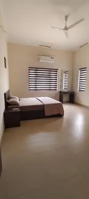 a bedroom with a large bed in a room at Aura Villa in Kozhikode