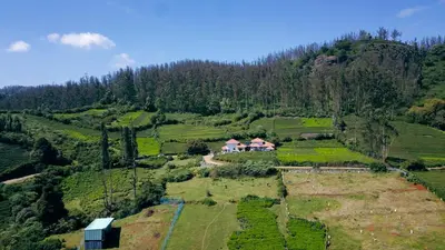 an aerial view of a house on a mountain at Green Leaves The Countryside Inn in Ooty