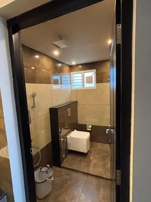 a bathroom with a sink and a toilet at Cicadas Nature Resort - A Frame cottages in Wayanad