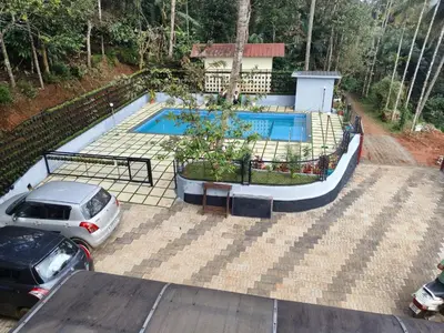 a car parked in front of a swimming pool at Wild mist in Padinjarathara