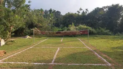 a soccer field with a net in a field at Diamond Villas Wayanad Entire Villa booking in Mananthavady