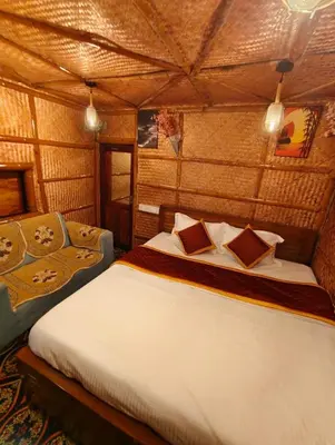 a bedroom with a large bed in a room at Wayanad Vista Family Bungalow in Padinjarathara