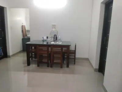 a kitchen with a table with a coffee maker on it at 2BHK Flat At Chalakudy Town Konuparamban Residence A1 in Kizhake Chālakudi