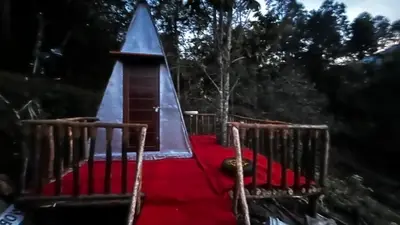 a playground with a tent and a red carpet at Alpine Mud house Kanthalloor in Kanthalloor