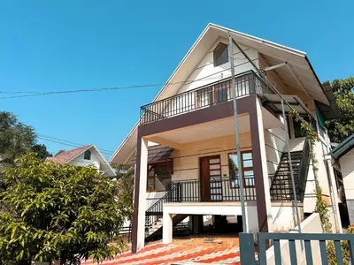 a house with a balcony and stairs on it at Chakkantharas Pool Villas in Athirappilly