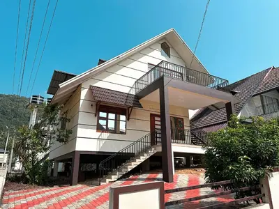 a house with a staircase in front of it at Chakkantharas Pool Villas in Athirappilly