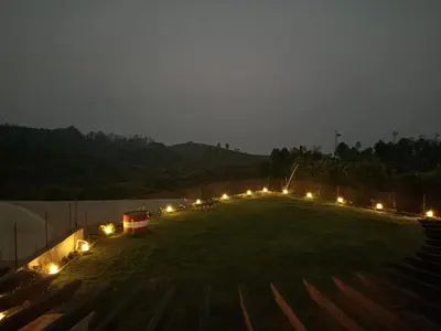 a large field with lights on it at night at Longwood Resorts in Kotagiri