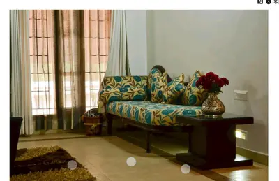 a living room with a couch and a vase of flowers at Deep view luxury villa Coffee Cottage Coorg in Madikeri