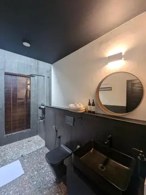 a bathroom with a sink and a mirror at Birdsong Luxury Pool Villa by Luxunlock Private Villas in Suntikoppa