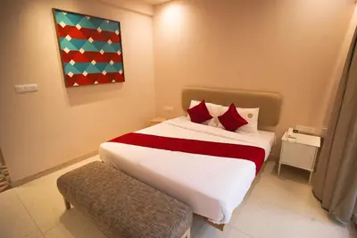 a bedroom with a large bed with red pillows at RIVERSCAPES by NOORJEHAN in Palakkad