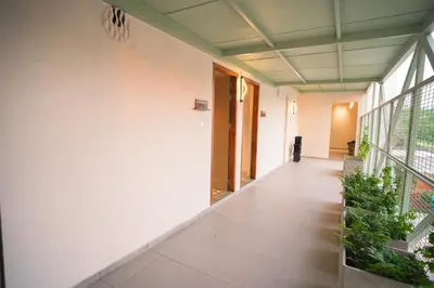 an empty hallway of a building with plants at RIVERSCAPES by NOORJEHAN in Palakkad