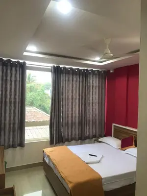 a bedroom with two beds and a window at low budget room at Kalpetta in Kalpetta