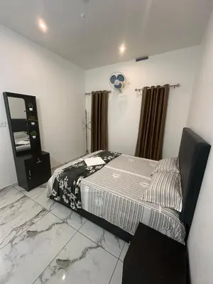 a bedroom with a bed in a room with marble floors at Homie Hub in Meppādi