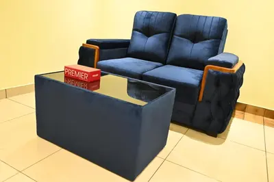 a blue reclining chair and a table in a room at Cous Cous Residency Hotel in Padinjarathara