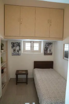 a small bedroom with a bed and a table at Perfect Gateway in Mysore
