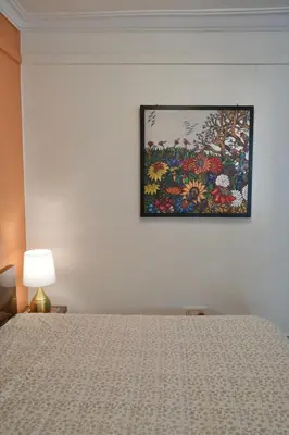 a bedroom with a bed and a painting on the wall at Perfect Gateway in Mysore