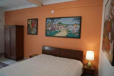 a bedroom with a bed and a painting on the wall at Perfect Gateway in Mysore