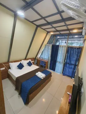 a bedroom with a bed and a large window at Goldenpeak Estate-Homestay-3Bed-A frame Holiday Home in Wayanad