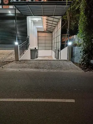 an entrance to a building at night with lights at Achandy Arcade in Kakkadampoyil