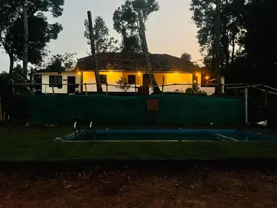 a tennis court in front of a house at kerala stay in Pinangode