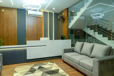 a living room with a couch and a staircase at FLY VIEW Airport Residency in Nedumbassery