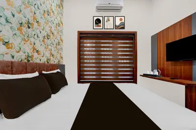 a bedroom with a large window with a television at Townhouse Thondayad Calicut Formerly Dream Casa in Kakkayam
