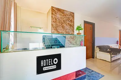 a hotel lobby with a hotel sign on a counter at Super Hotel O Kaveri Road Mysore in Mysore