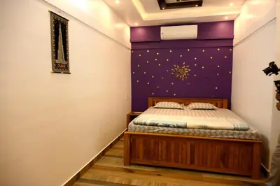 a bedroom with a bed with a purple wall at Sidharth Resort, Vadavannur in Kollengode