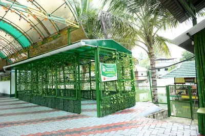 a green cage filled with animals in a building at Sidharth Resort, Vadavannur in Kollengode