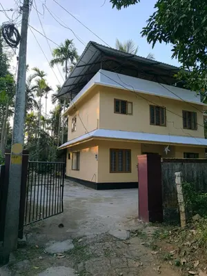 a house with a gate in front of it at Serenity Home Stay in Sultan Bathery