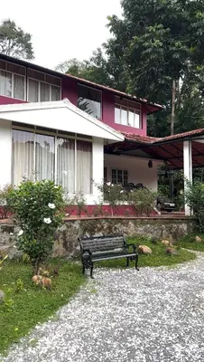 a bench sitting in front of a house at Vintage Coffee Estate 3 Bedrooms 1 Cottage in Wayanad