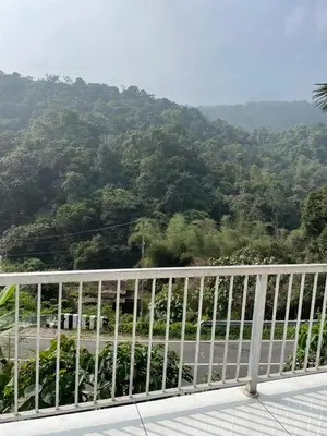a balcony with a view of a mountain at aphrodite home stay in Pinangode