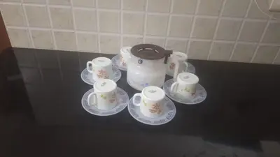 a group of cups and saucers on a counter at Atlas Celestial Park in Nedumbassery