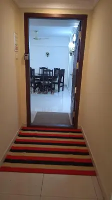 a hallway with a door leading to a dining room at Atlas Celestial Park in Nedumbassery