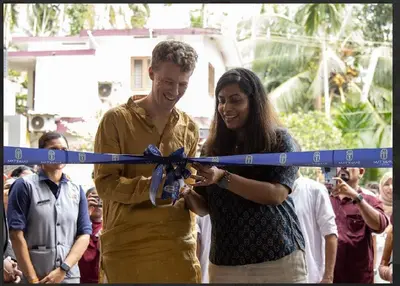 a man and a woman cutting a ribbon at Sanketam Motel in Calicut