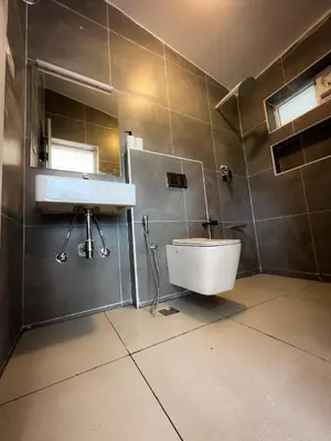 a bathroom with a sink and a toilet at Away From Home - 3 - Rooms In Ooty, Home Stay Ooty in Ooty