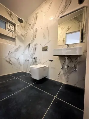a white bathroom with a sink and a toilet at Away From Home - 3 - Rooms In Ooty, Home Stay Ooty in Ooty