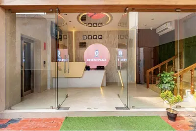 a room with glass doors in a building at Hotel Beverly Plaza Kozhikode in Kozhikode