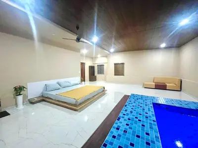a bedroom with a bed and a swimming pool at Whitehouse homestay in Kannur