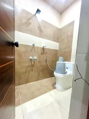 a bathroom with a toilet and a shower at Whitehouse homestay in Kannur