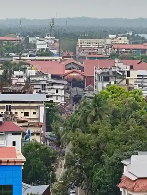 a cityscape of a city with houses and trees at Posh 1 BHK Apt with Temple View in Guruvayur C1301 in Guruvāyūr