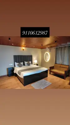 a bedroom with a king sized bed and a couch at The Cozy Clouds Hill Stay in Napoklu